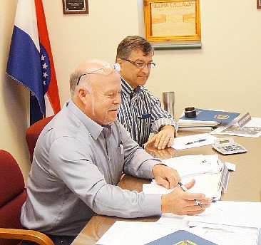 Callaway County commissioners Gary Jungermann, left, and Roger Fischer look over paperwork during a December 2018 meeting.