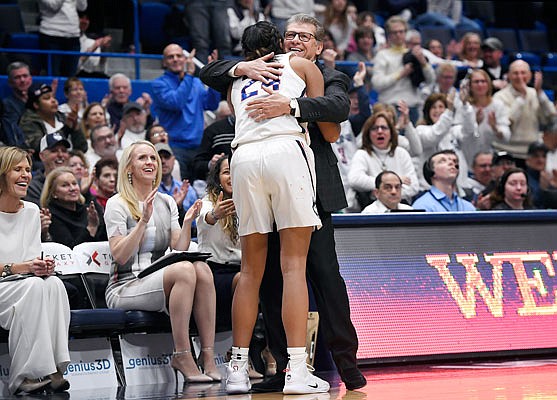 Connecticut head coach Geno Auriemma embraces Napheesa Collier after Collier comes out late in Monday night's win against South Carolina in Hartford, Conn.