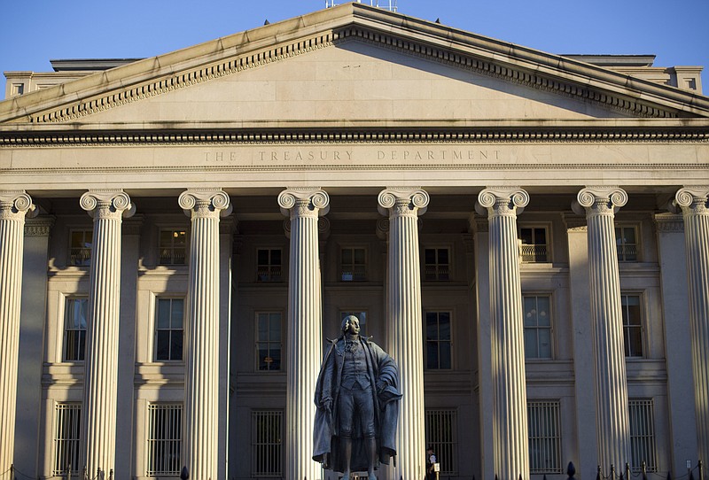 FILE - This June 8, 2017, file photo shows the U.S. Treasury Department building in Washington. The national debt has passed a new milestone, topping $22 trillion for the first time. The Treasury Department's daily statement shows that total outstanding public debt stands at $22.01 trillion. It stood at $19.95 trillion when President Donald Trump took office on Jan. 20, 2017. (AP Photo/Pablo Martinez Monsivais, File)