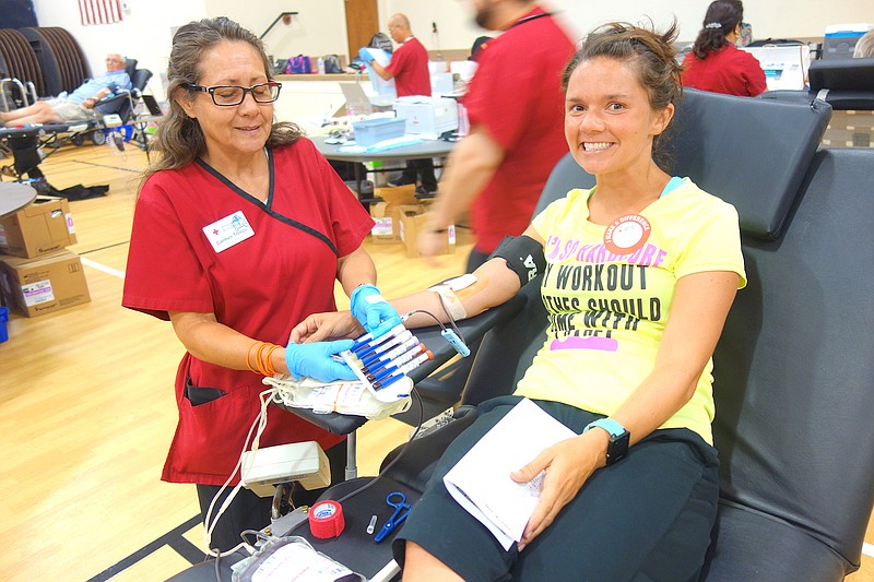 Katie Finley, right, relaxes as Carmen Trenco finishes drawing her blood during a 2017 drive. A blood drive is planned for next Tuesday at Grand Prairie Baptist Church in Auxvasse.