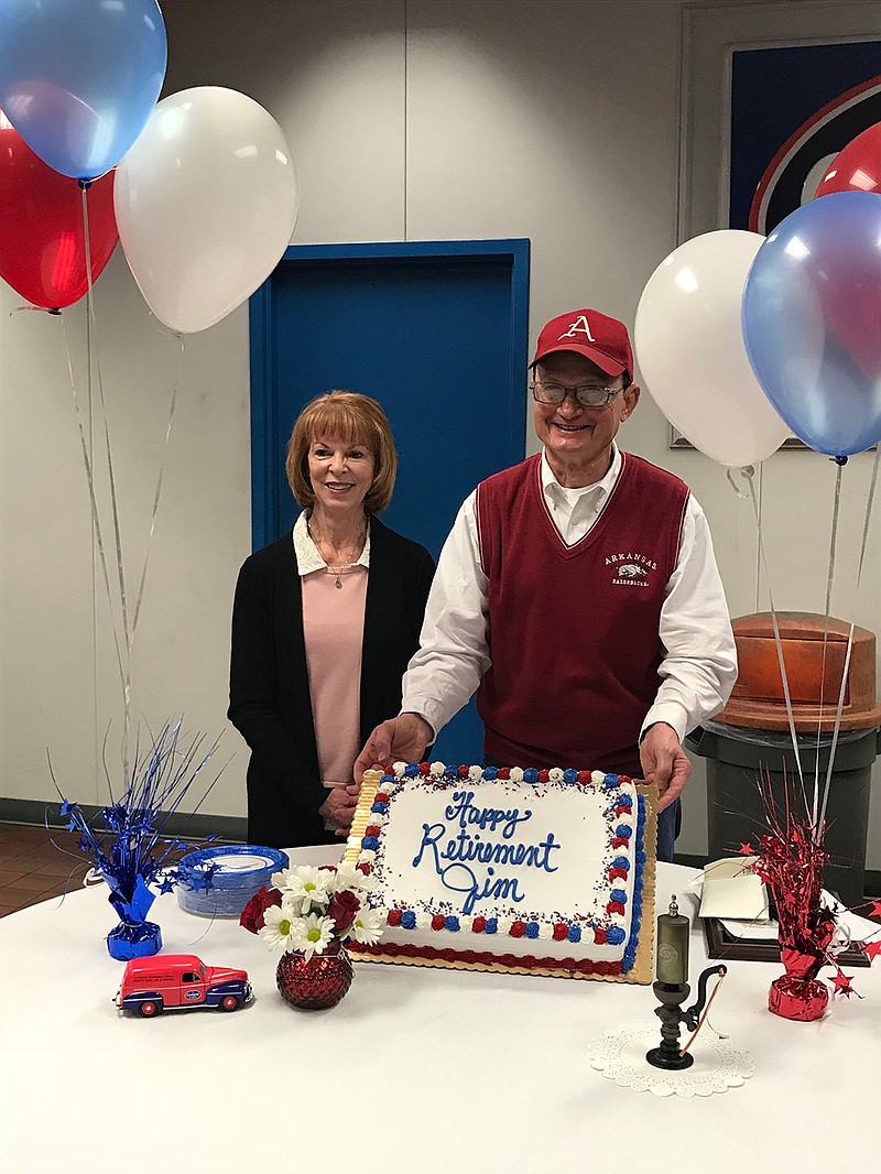Jim Narens, right, and his wife, Carolyn, were presented with a 50-year retirement cake recently at the Cooper Tire Plant in Texarkana, Ark. Narens achieved a rare milestone with 50 years of service to Cooper Tire.  (Submitted photo)
