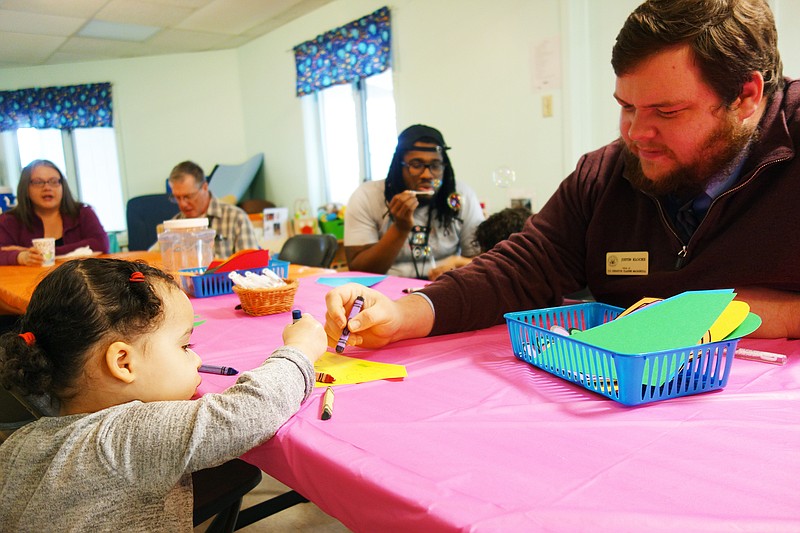 <p>Helen Wilbers/For the News Tribune</p><p>Justin Klocke, from former Sen. Claire McCaskill’s office in Columbia, colors with Nora Roizer at Callaway County Head Start during the 2018 100 Man Lunch. The annual event gives children a chance to spend time with male role models.</p>