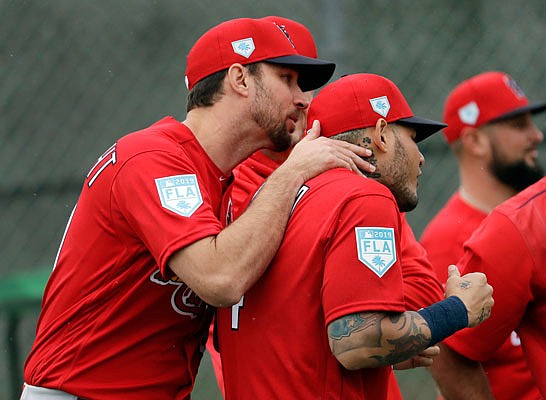 Cardinals catcher Yadier Molina recoils as he gets surprised Wednesday by teammate Adam Wainwright during spring training in Jupiter, Fla.