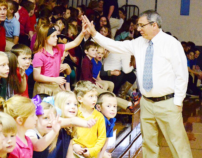 Principal Steve Gonzalez high-fives students Wednesday at Trinity Lutheran School prior to the Kids Heart Challenge assembly in the gym. Stephanie Jump, of the American Heart Association, was on hand to encourage heart-healthy behavior to the students, encouraging them to drink more water and exercise.