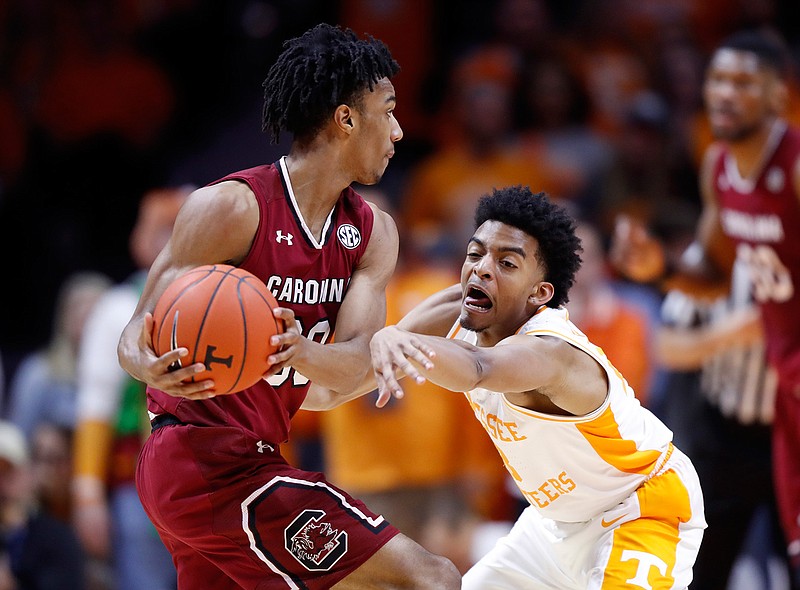 Tennessee guard Jalen Johnson (13) attempts to steal the ball from South Carolina guard A.J. Lawson (00) during the first half of an NCAA college basketball game Wednesday, Feb. 13, 2019, in Knoxville, Tenn.  (AP photo/Wade Payne)