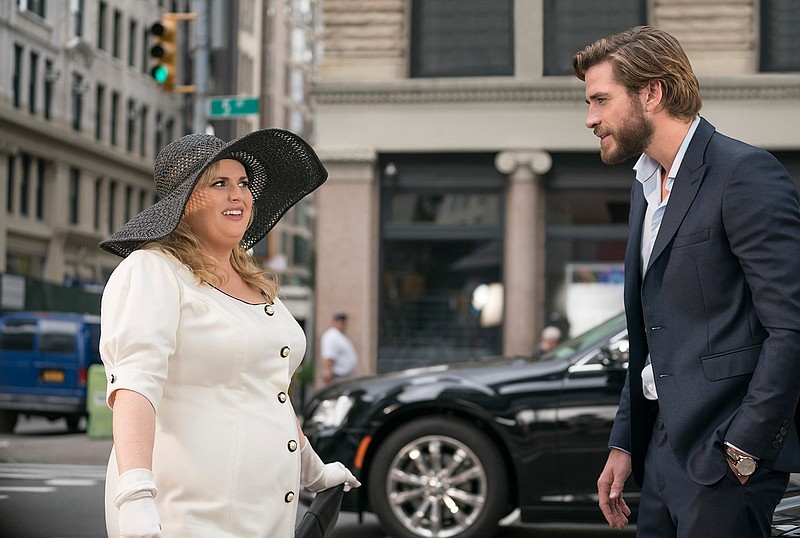 This image released by Warner Bros. Pictures shows Rebel Wilson, left, and Liam Hemsworth in a scene from "Isn't It Romantic." (Michael Parmelee/Warner Bros. Pictures via AP)