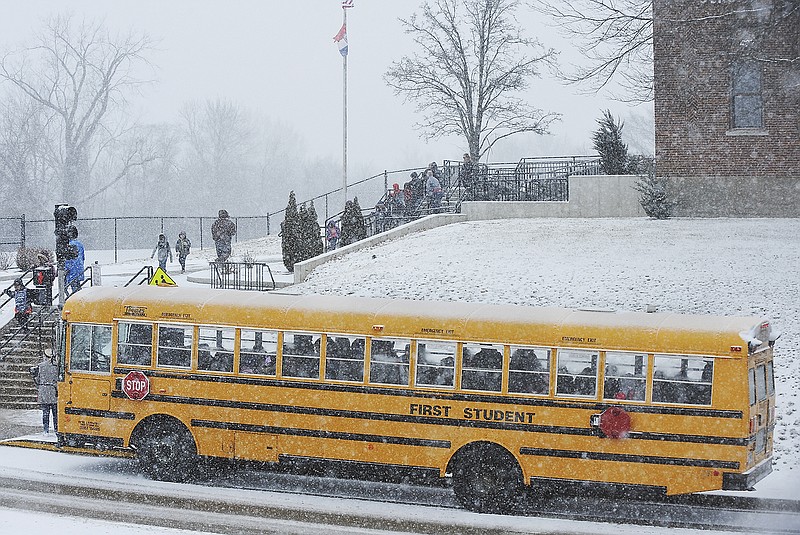 Students from East Elementary School board a school bus Friday, Feb. 15, 2019, as Jefferson City Public Schools announced early dismissal due to the accumulating snow.