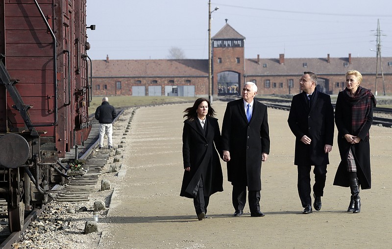 United States Vice President Mike Pence and his wife Karen Pence, left, walk with Poland's President Andrzej Duda and his wife Agata Kornhauser-Duda, right, during their visit at the Nazi concentration camp Auschwitz-Birkenau in Oswiecim, Poland, Friday, Feb. 15, 2019. (AP Photo/Michael Sohn)