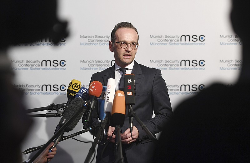 German Minister of Foreign Affairs Heiko Maas talks to the media at the Munich Security Conference in Munich, Germany, Friday, Feb. 15, 2019. (Tobias Hase/dpa via AP)
