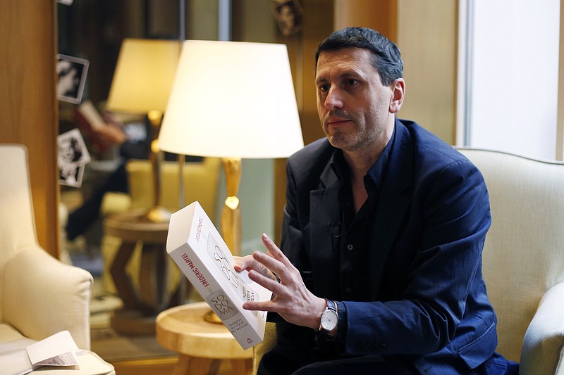 French writer Frederic Martel gestures during an interview with Associated Press, in Paris, Friday, Feb. 15, 2019. In the explosive book "In the Closet of the Vatican" author Frederic Martel describes a gay subculture at the Vatican and calls out the hypocrisy of Catholic bishops and cardinals who in public denounce homosexuality but in private lead double lives. (AP Photo/Thibault Camus)