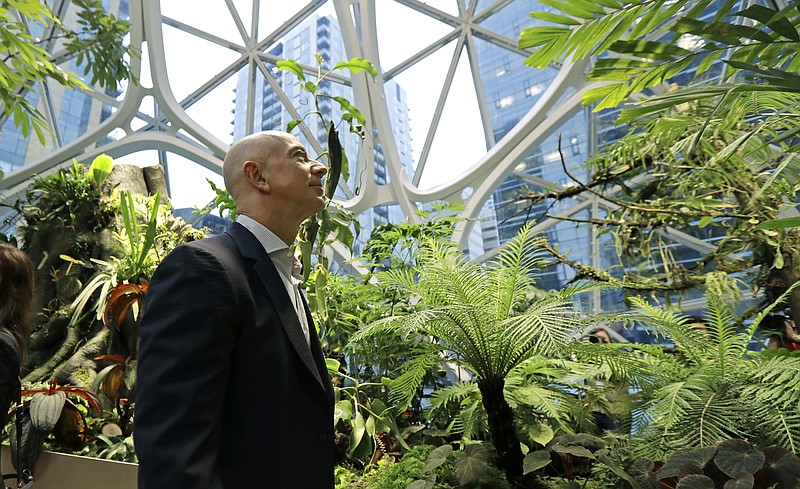 FILE- In this Jan. 29, 2018, file photo Jeff Bezos, the CEO and founder of Amazon.com, takes a walking tour of the Amazon Spheres in Seattle. Amazon has had a complicated few weeks with its cancellation of a New York headquarters Thursday, Feb. 14, 2019, and extortion claims last week related to intimate photos taken by its founder. Experts say the events are unlikely to pose much of a threat to Amazon’s business. But the company will continue to face more challenges as it grows larger. (AP Photo/Ted S. Warren, File)