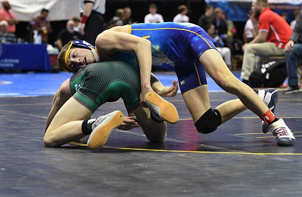 Jason Strope of Fatima tries to keep Dallas Grippando of Mid-Buchanan on the mat Friday during their 106-pound match in the Class 1 state wrestling championships at Mizzou Arena.