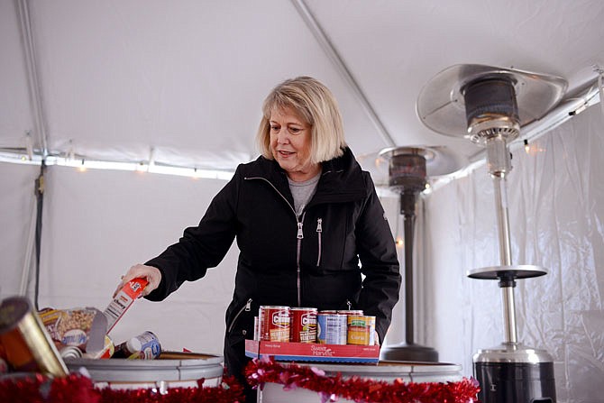 Missouri's first lady Teresa Parson places food donations into barrels Saturday during the "Heart for the Hungry" food drive at the Governor's Mansion, which she refers to as the "People's House." Visitors were encouraged to donate non-perishable donations such as canned foods or diapers. Afterward, visitors were invited to take a special weekend tour of the mansion.