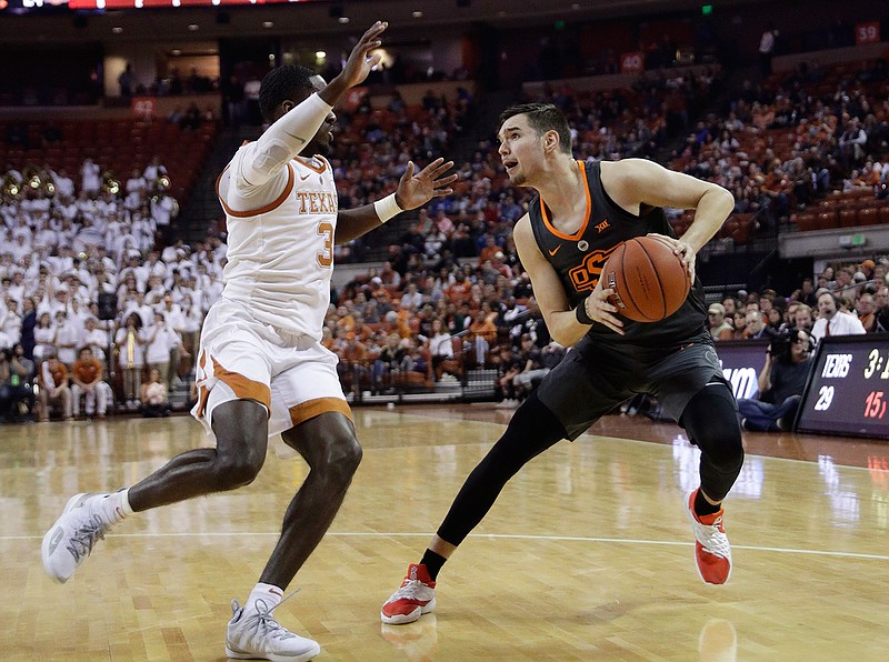 Oklahoma State guard Thomas Dziagwa (4) is pressured by Texas guard Courtney Ramey (3) during the first half of an NCAA college basketball game, Saturday, Feb. 16, 2019, in Austin, Texas. (AP Photo/Eric Gay)