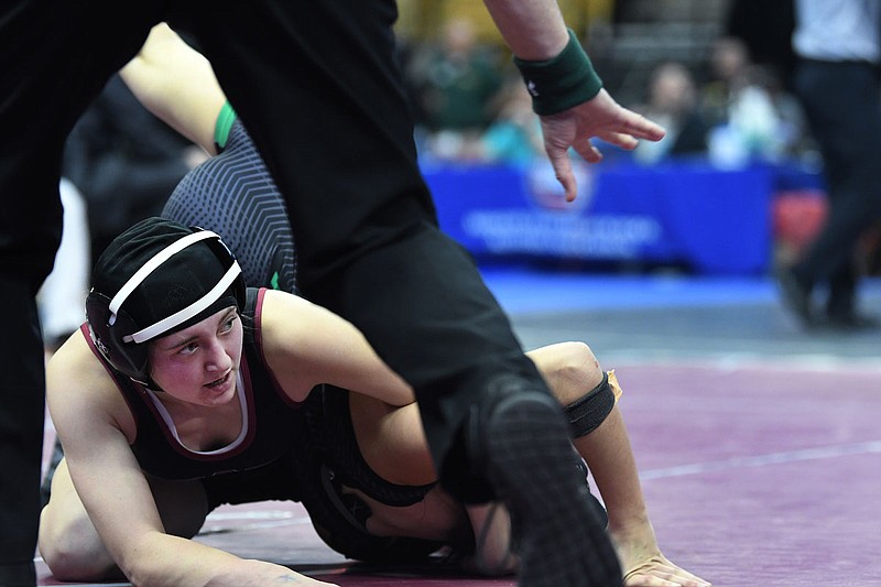 Osage's Abbey Cordia looks up while holding onto Genevieve Nickelson of Ste. Genevieve during the 131-pound match Saturday in the Class 1 girls state wrestling championships at Mizzou Arena.