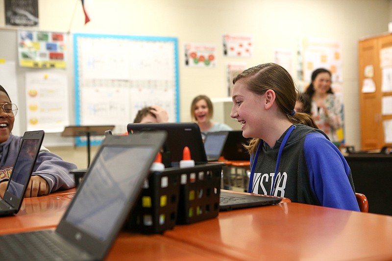 Students at Texas Middle School read stories from their laptops to the class Wednesday in Texarkana, Texas.