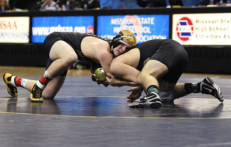 Michael Trotter of Versailles holds onto Justin Wright of Lathrop during the182-pound title match Saturday in the Class 1 state championships at Mizzou Arena.