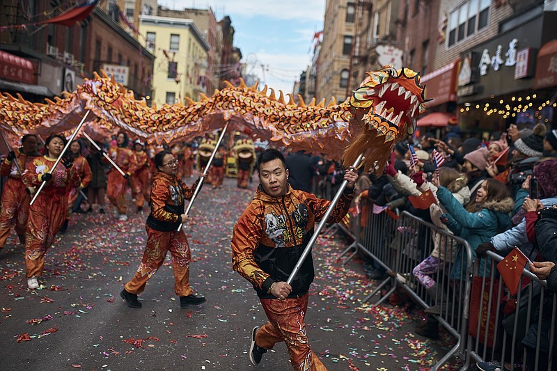 A member of a dragon dance group carries the head of the dragon during the Chinese Lunar New Year parade in Chinatown in New York, Sunday, Feb. 17, 2019. (AP Photo/Andres Kudacki)