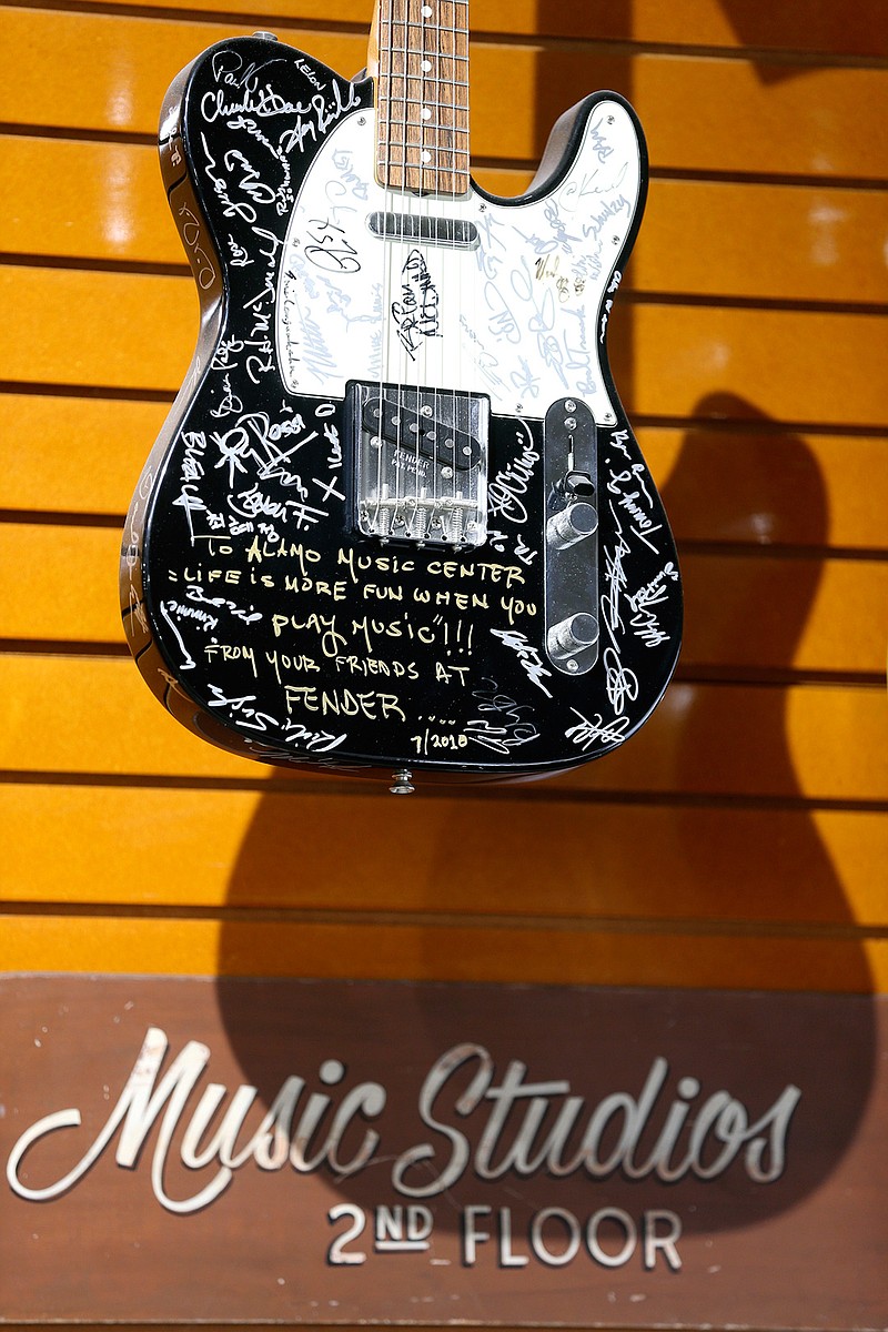 A Fender Telecaster signed by the luthiers at the Fender factory hangs on the wall Jan. 30, 2019, at Alamo Music Center's downtown location in San Antonio. The family-owned musical instrument dealer turns 90 this year and ranks among the oldest music stores in Texas. 