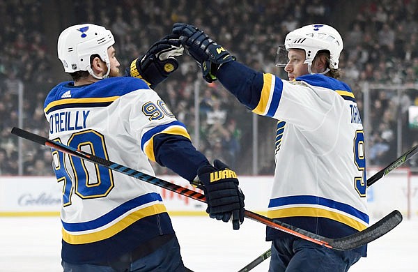 Ryan O'Reilly congratulates Blues teammate Vladimir Tarasenko after a goal during the first period of Sunday afternoon's game against the Wild in St. Paul, Minn.