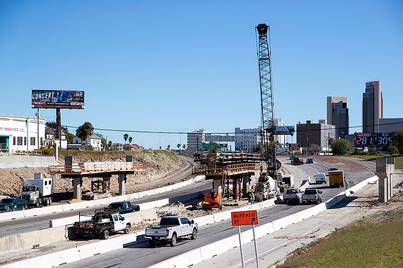 In this Dec. 21, 2018 photo, construction crews work on the new Harbor Bridge project on Interstate-37 in Corpus Christi, Texas. Construction on a $930 million project to replace a Corpus Christi bridge is behind schedule despite reaching a major milestone this month.  The Corpus Christi Caller-Times reports that construction company Flatiron/Dragados recently acknowledged that the replacement of the 60-year-old Harbor Bridge likely won't be complete by its April 2020 deadline. The first span of the bridge was put into place on the north side of the Corpus Christi Ship Channel this month. (Rachel Denny Clow/Corpus Christi Caller-Times via AP, File)