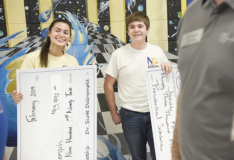 Fatima seniors Alyssa Struemph and Jacob Knaebel received Presidential Scholarships, presented to them Monday at Fatima High School. The $93,000 checks will cover tuition for four years at Columbia College.