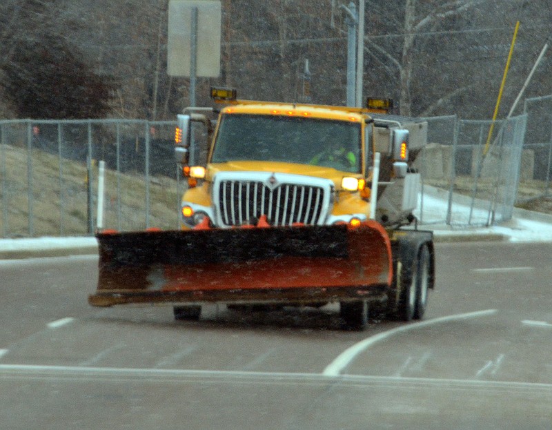 A snow plow drives through downtown Jefferson City on Feb. 7, 2019.