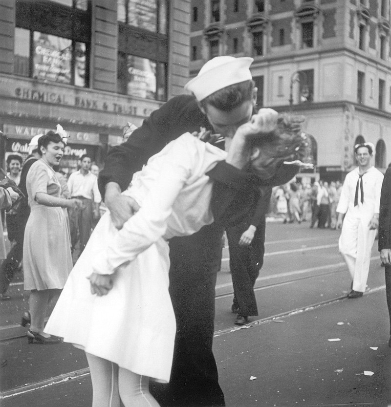 FILE - In this Aug. 14, 1945 file photo provided by the U.S. Navy, a sailor and a woman kiss in New York's Times Square, as people celebrate the end of World War II. The ecstatic sailor shown kissing a woman in Times Square celebrating the end of World War II has died. George Mendonsa was 95. It was years after the photo was taken that Mendonsa and Greta Zimmer Friedman, a dental assistant in a nurse’s uniform, were confirmed to be the couple. (Victor Jorgensen/U.S. Navy, File)