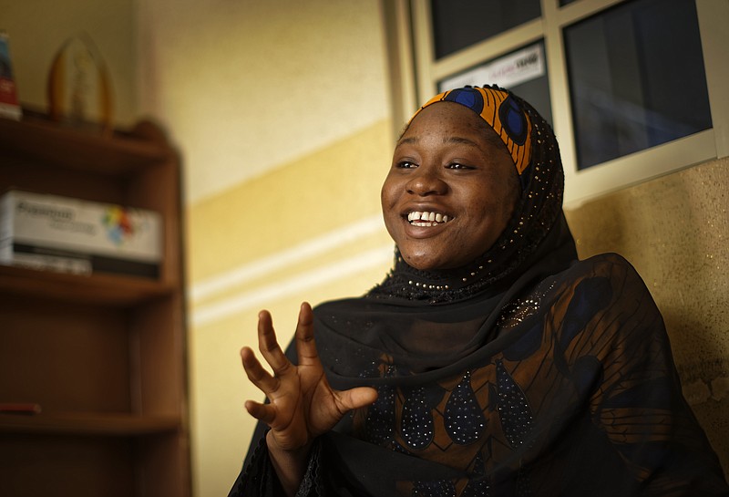 In this photo taken Friday, Feb. 15, 2019, Zainab Sulaiman Umar, 26, a candidate for the State House of Assembly in Kumbotso constituency, Kano state, speaks to the Associated Press at an activists office in Kano, northern Nigeria. Umar is among dozens of first-time female candidates in a country where the percentage of women in parliament is one of the lowest in the world, under 7 percent, and the idea of a female president brings a belly laugh from many men. (AP Photo/Ben Curtis)