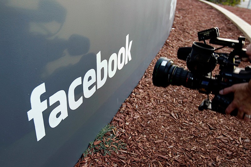 A television photographer shoots the sign outside of Facebook headquarters on May 18, 2012, in Menlo Park, Calif. 