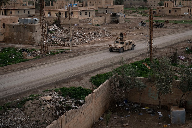 A Humvee drives on Sunday in a village recently retaken from Islamic State militants by U.S.-backed Syrian Democratic Forces near Baghouz, Syria. Islamic State militants are preventing more than 1,000 civilians from leaving a tiny area still held by the extremist group in a village in eastern Syria, a spokesman for the U.S.-backed Syrian militia fighting the group said Sunday. 