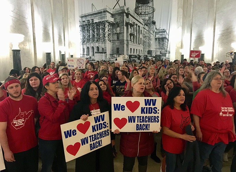 Striking West Virginia teachers and supporters rally outside the House of Delegates chambers Tuesday, Feb. 19, 2019, at the state Capitol in Charleston, W.Va. Teachers are opposed to a complex education bill making its way through the Legislature. (AP Photo/John Raby)
