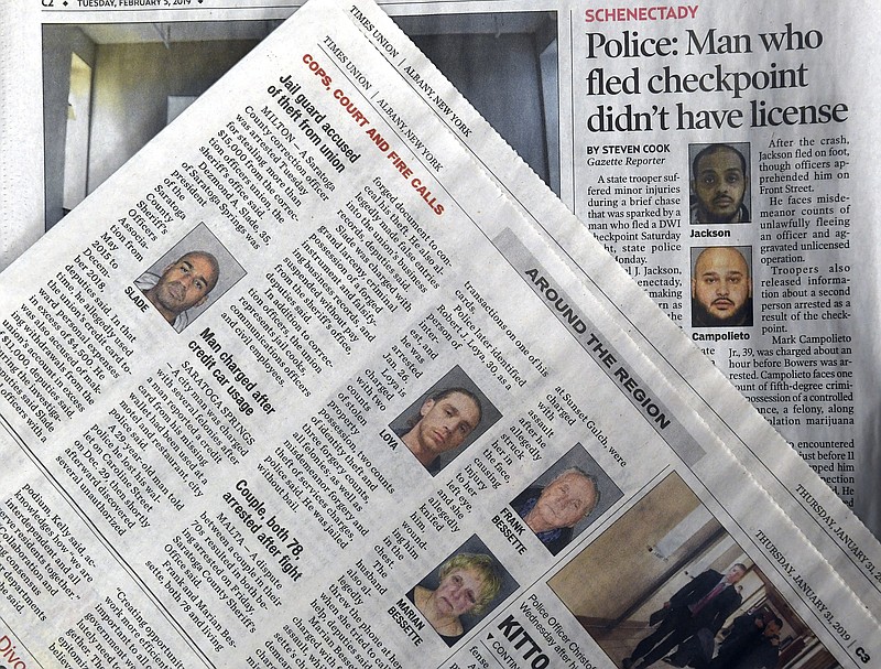 This Monday, Feb. 11, 2019, photo shows a view of published New York state newspapers showing police mug shots of arrested people in Albany, N.Y. New York’s governor doesn’t want state police to routinely release mug shots of criminal suspects, or arrest booking records about exactly what they are accused of doing. Democratic Gov. Andrew Cuomo’s proposal is the latest by states aimed at curtailing websites that claim to be able to remove mugshots from the web, for a free. (AP Photo/Hans Pennink)