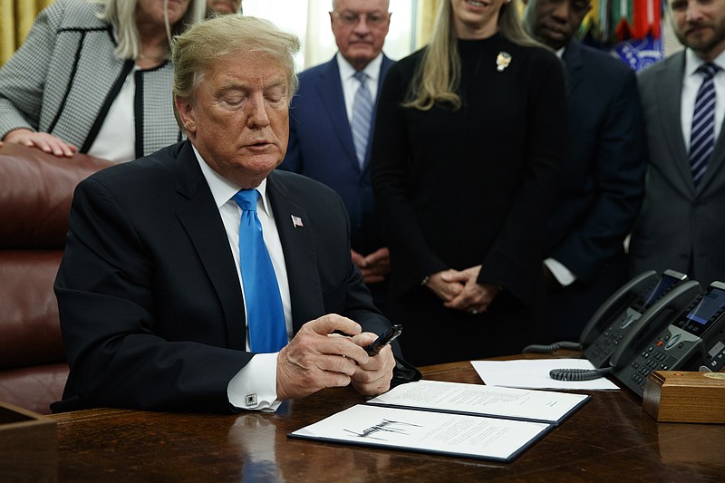 President Donald Trump pauses during a signing event for "Space Policy Directive 4" in the Oval Office of the White House, Tuesday, Feb. 19, 2019, in Washington. (AP Photo/ Evan Vucci)