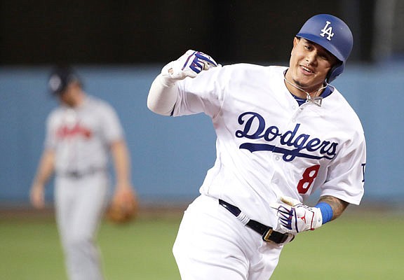 Manny Machado celebrates his two-run home run for the Dodgers in Game 2 of the National League Division Series against the Braves in Los Angeles last season.