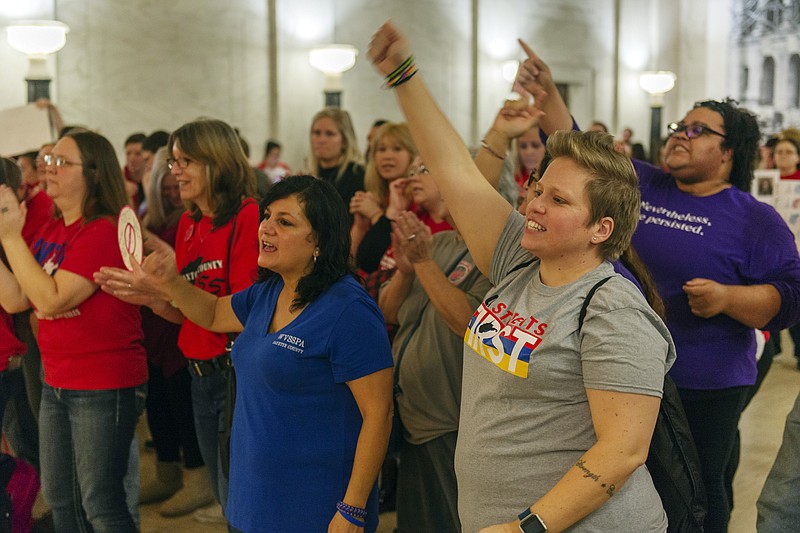 CORRECTS DAY OF WEEK TO WEDNESDAY - Teachers and school personnel, on the second day of a statewide strike, demonstrate outside the House of Delegates chamber, Wednesday, Feb. 20, 2019, at the West Virginia State Capitol in Charleston, W.Va. West Virginia public school teachers are striking for a second day even though legislation they loathed was tabled in the House of Delegates. Schools in 54 of the state's 55 counties were closed Wednesday. The lone holdout again was Putnam County. (Craig Hudson/Charleston Gazette-Mail via AP)