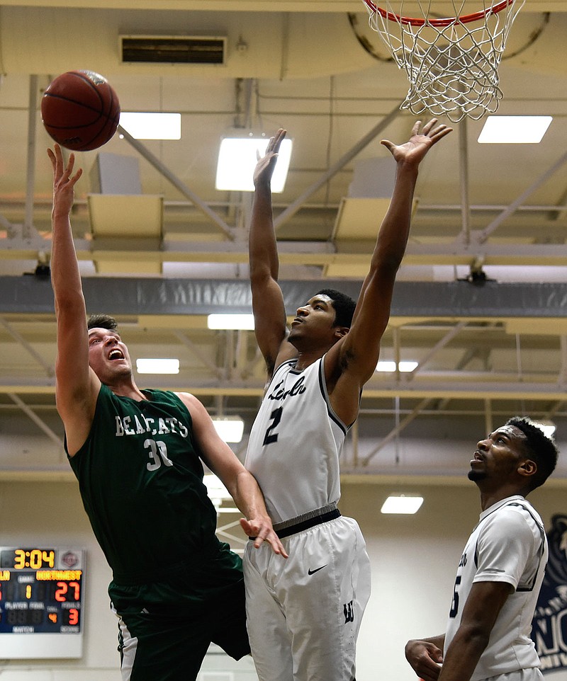 Terrance Smith of Lincoln defends as Ryan Hawkins of Northwest Missouri shoots a layup during a game earlier this month at Jason Gym. Northwest Missouri is ranked first in the Central Region rankings while Lincoln is eighth.