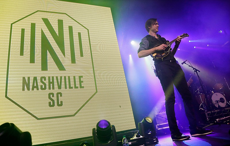 A band performs as the logo of the Nashville Soccer Club is displayed at the unveiling of the MLS team's name, logo and colors Wednesday, Feb. 20, 2019, in Nashville, Tenn. The expansion franchise is due to start play in 2020. (AP Photo/Mark Humphrey)