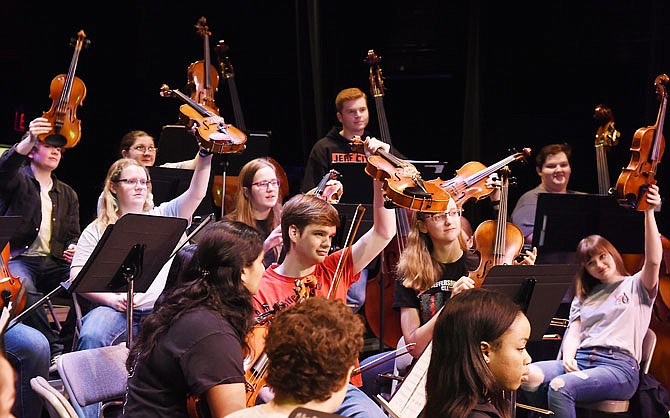 When asked by Director Amy Veile, students in the Jefferson City High School Symphonic Orchestra held up their respective instruments during Thursday's Fine Arts Recruitment Day at Miller Performing Arts Center. Public elementary school fifth-grade students were invited to attend to watch and listen to the orchestra to try and pique the younger students' interests.The auditorium at the Etta and Joseph Miller Performing Arts Center was named Thursday after the late David R. Goller.