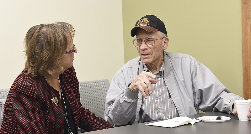 Truman VA Hospital nurse executive Cheryle Kelly visits Thursday with Navy veteran Ken Wildhaber. Kelly — who typically is found at Truman VA Hospital in Columbia — was in Jefferson City and took time to visit with numerous veterans including Wildhaber, who served three tours during the Korean War. The Community-Based Outpatient Clinic in Jefferson City held an open house and ribbon cutting in its new location at 3430 W. Edgewood Drive during which veterans could chat over coffee.