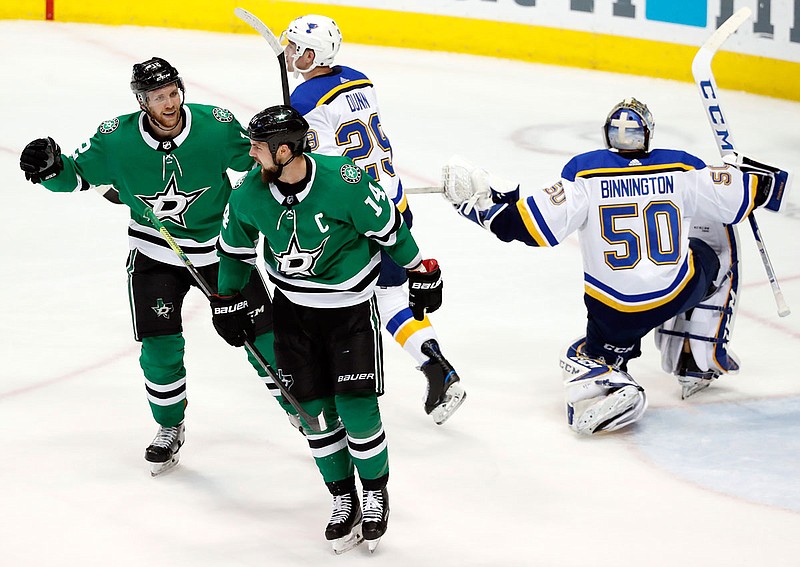 Stars teammates Radek Faksa (12) and left wing Jamie Benn (14) celebrate Benn's goal in front of Blues' Vince Dunn (29) and goaltender Jordan Binnington during the second period of Thursday night's game in Dallas.