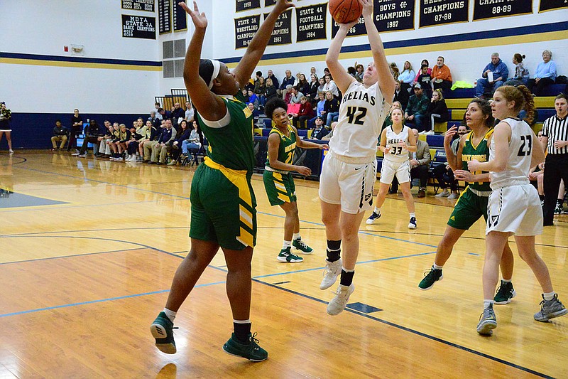 Meagan Engelbrecht of Helias takes a shot over Maddie Collier of Rock Bridge during Thursday night's game at Rackers Fieldhouse.