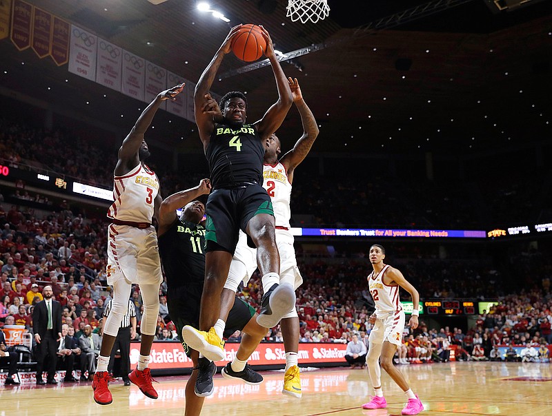 Baylor guard Mario Kegler, center, pulls down a rebound during the second half of the team's NCAA college basketball game against Iowa State, Tuesday, Feb. 19, 2019, in Ames, Iowa. Baylor won 73-69. (AP Photo/Matthew Putney)