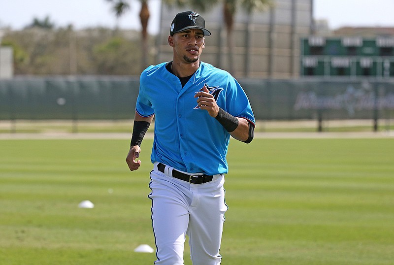 In this Feb. 18, 2019, file photo, Miami Marlins outfielder Victor Victor Mesa runs drills at the team's spring training baseball facility in Jupiter, Fla. Last offseason the Miami Marlins signed a highly touted Cuban defector, and if he lives up to his name, he could help revive a franchise that has done nothing but lose and lose: Victor Victor Mesa. (David Santiago/Miami Herald via AP, File)