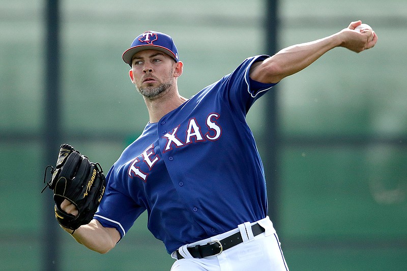  In this Feb. 15, 2019, file photo, Texas Rangers pitcher Mike Minor throws during spring training baseball practice in Surprise, Ariz. The Rangers were cautious with Minor last season in his Texas debut and his return to starting. He missed two years recovering from shoulder surgery and was a full-time reliever for Kansas City in 2017. Now the lefty is likely the Rangers' opening day starter. (AP Photo/Charlie Riedel, File)