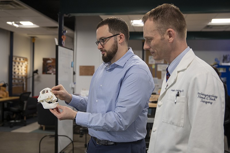 Dr. Joseph Curry, right, and Robert Pugliese look at a 3D-printed model of the jaw of a Haitian woman with a disfiguring tumor. (Heather Khalifa/Philadelphia Inquirer/TNS) 