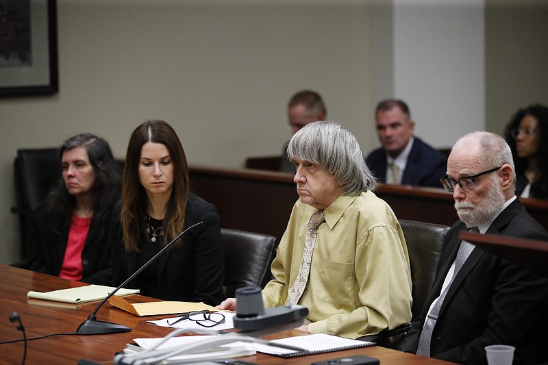 David Turpin, second from right, and wife, Louise, far left, sit in a courtroom with their attorneys, Allison Lowe, second from left, and David Macher Friday, Feb. 22, 2019, in Riverside, Calif. The California couple who shackled some of their 13 children to beds and starved them have pleaded guilty to torture and other abuse. (AP Photo/Jae C. Hong, Pool)