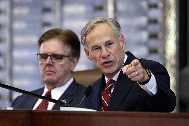 Texas Gov. Greg Abbott, right, gives his State of the State Address on Feb. 5 as Texas Lt. Gov. Dan Patrick, left, listens in the House Chamber in Austin. Texas Gov. Greg Abbott doesn't flash the White House ambitions of his predecessors, but the Republican has built his own distinction by taking in more donor cash than any governor in history.