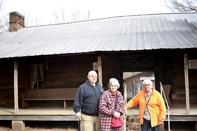 The Will Reed Farm House was built in Little River County, Ark., within a mile of Alleene, Ark., in 1895. Curator Gary Tong, Mildred Kanakis and Vivian Keeney inspected the cabin.