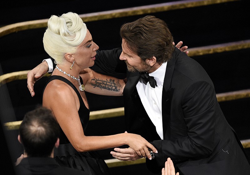 Bradley Cooper, right, congratulates Lady Gaga in the audience after she is announced winner for best original song for "Shallow" from "A Star Is Born" at the Oscars on Sunday, Feb. 24, 2019, at the Dolby Theatre in Los Angeles. (Photo by Chris Pizzello/Invision/AP)